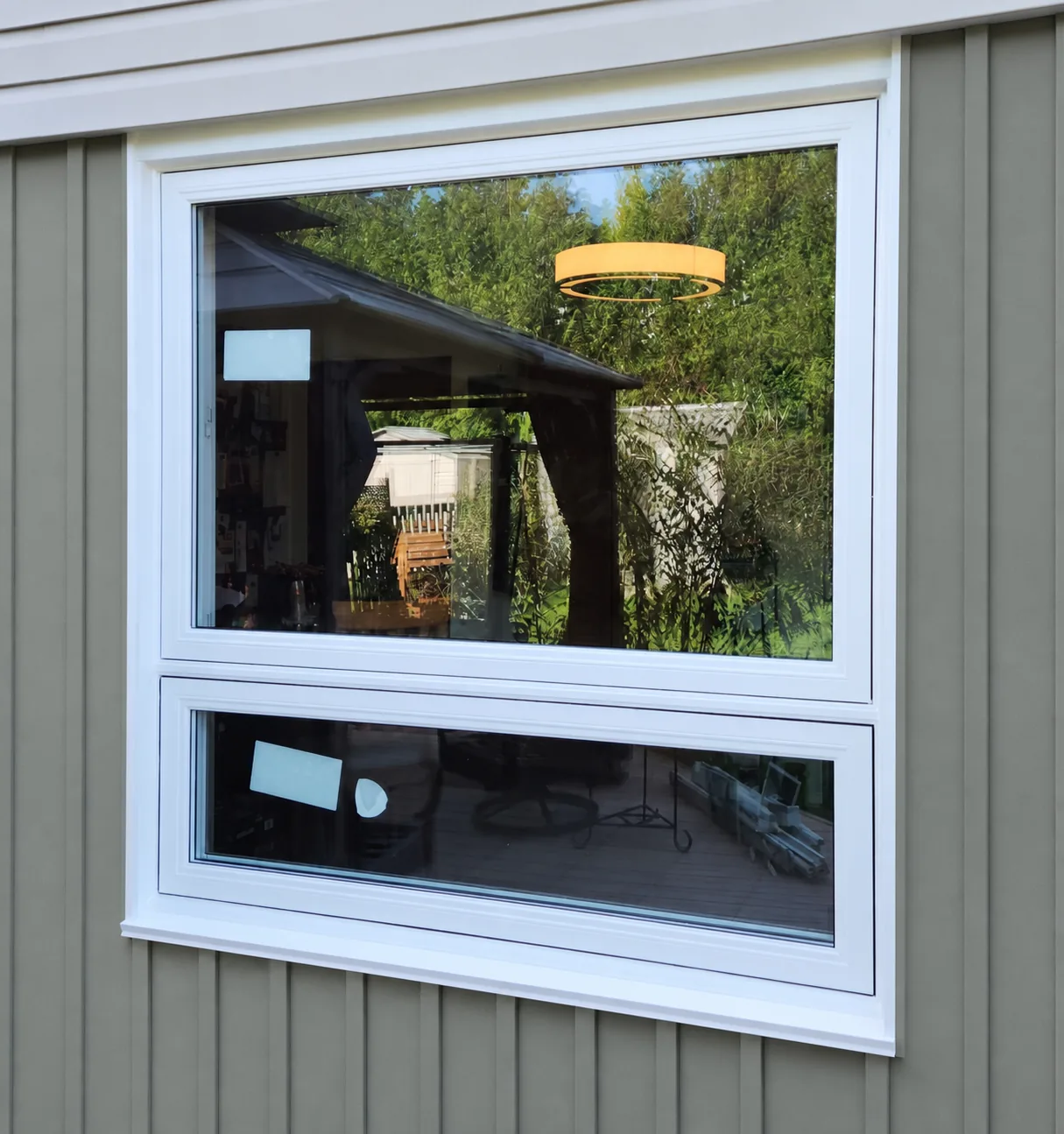White vinyl awning window open from the bottom on a Rocky View County home